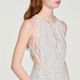 Model wearing Sandro Womens French Dress in ecru and blue stripe with lace trim detail and open back cutout.