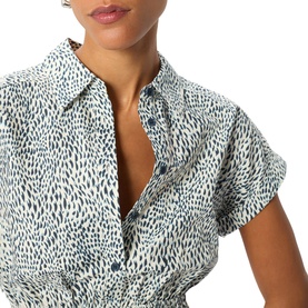 Model wearing Whistles blue animal print short sleeve shirt dress, shown from shoulders up, with collar and button detail visible