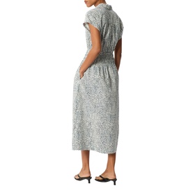 Model wearing Whistles blue dalmatian-print midi dress with smocked waist, cap sleeves, and V-neckline, styled with black heeled mules