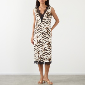 Model wearing Ganni Zebra Print Lace-Trim Slip Dress in Egret, midi length with black lace trim V-neckline and hem, styled with tan sandals.