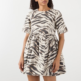 Model wearing Ganni Egret zebra-print cotton mini dress with short sleeves and gathered drop-waist skirt