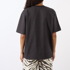 Model wearing Ganni Tiger Heavyweight Logo T-Shirt in Phantom, back view, with zebra-print trousers. Oversized fit, dropped shoulders, short sleeves.