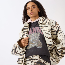 Model wearing Ganni Tiger Heavyweight Logo T-Shirt in Phantom with tiger graphic print, styled with a zebra-print jacket.