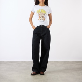 Model wearing Ganni Tiger Logo Baby Tee in Bright White with yellow tiger graphic, styled with black wide-leg jeans and brown sandals.