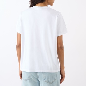 Model wearing Ganni Strawberry Logo T-Shirt in Bright White, crew neck, short sleeves, back view, styled with light blue jeans