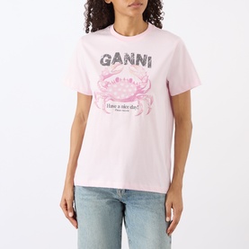 Model wearing Ganni Crab Logo T-Shirt in Chalk Pink with crew neck and crab graphic print, styled with light blue jeans.