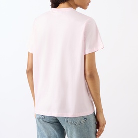 Model wearing Ganni Crab Logo T-Shirt in Chalk Pink, back view, crew neck, short sleeves, straight hem, styled with light blue jeans