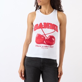 Model wearing Ganni Cherry Logo Ribbed Tank Top in Bright White with red cherry graphic, paired with black jeans.