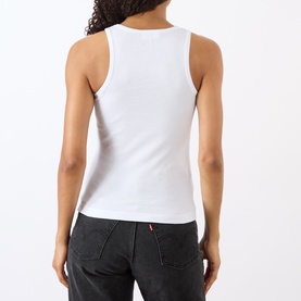 Model wearing Ganni Cherry Logo Ribbed Tank Top in Bright White, back view, ribbed cotton, paired with dark grey jeans.