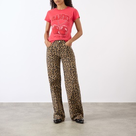 Model wearing Ganni Cherry Logo Baby Tee in High Risk Red with leopard print wide-leg jeans and patent black shoes.
