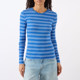 Model wearing Ganni Butterfly Logo Striped Long-Sleeved Top in Nouvean Navy, ribbed crew neck with stripe pattern, styled with light wash jeans