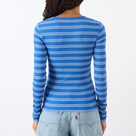 Model wearing Ganni Butterfly Logo Striped Long-Sleeved Top in Nouveau Navy, ribbed stripe, crew neck, long sleeves, styled with light-wash jeans.