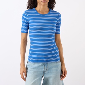 Model wearing Ganni Butterfly Logo Striped T-Shirt in Nouvean Navy, ribbed cotton with crew neck and short sleeves, styled with light wash jeans.