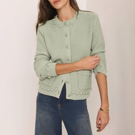 Model wearing Mint Velvet Bobble Detail Knitted Cardigan in green with crew neck, bobble trim, patch pockets and button front, styled with blue jeans.