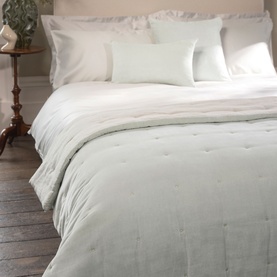 Christys platinum quilted bedspread draped over a made bed with white pillows and linen in a styled bedroom setting.