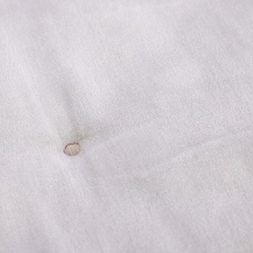 Christys platinum fabric close-up detail showing textured weave and small decorative button feature in neutral tone