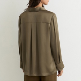 Model wearing Reiss khaki green long-sleeve blouse, shown from behind, featuring a centre back pleat and wide cuffs.