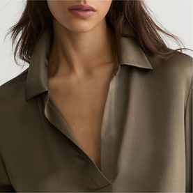 Model wearing Reiss khaki green satin-finish dress with open collar neckline, close-up detail shot