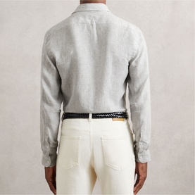 Model wearing Reiss white/thyme green linen shirt, back view, styled with cream trousers and woven leather belt
