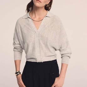 Model wearing Mint Velvet Cream Open Collar Trim Top with V-neckline and lace trim detail, styled with black wide-leg trousers and gold jewellery.