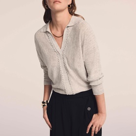 Model wearing Mint Velvet Cream Open Collar Trim Top with V-neckline and trim detail, styled with black wide-leg trousers and gold bangles.