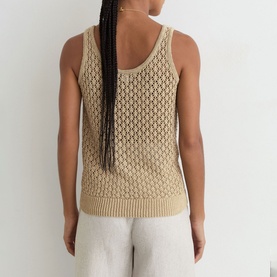 Model wearing Reiss beige open-knit crochet vest top, back view, styled with light grey trousers