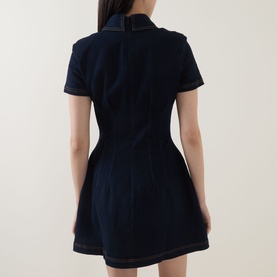 Model wearing Odd Muse dark blue denim mini dress, rear view, showing collared neckline, short sleeves, and contrast topstitching.