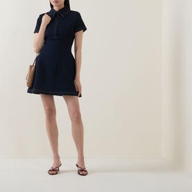 Model wearing Odd Muse dark blue mini dress with collar and cap sleeves, styled with brown strappy flat sandals and a tan bag.