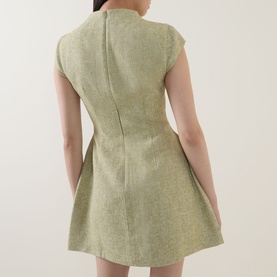 Model wearing Odd Muse Tweed Flap Pocket Mini Dress in green, rear view showing zip fastening, fitted waist and voluminous mini skirt.