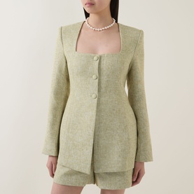 Model wearing Odd Muse green textured blazer with matching shorts and pearl necklace
