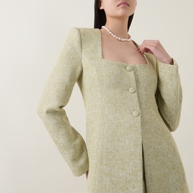 Model wearing Odd Muse green textured blazer-style top with square neckline and button detail, styled with a pearl necklace.