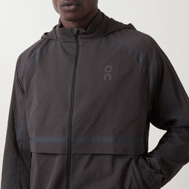 Model wearing On Running Casual Jacket in Espresso, lightweight hooded zip-up with tonal logo and panelled design