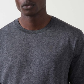 Model wearing On Running T-Shirt in Ember Heather, close-up of crew neckline in marl fabric with long sleeves visible.