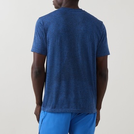 Model wearing On Running T-Shirt in Jay Heather, rear view, styled with blue shorts.