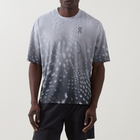 Model wearing On Running Performance T-Shirt in Espresso, featuring all-over graphic print, crew neck, short sleeves, styled with black shorts.