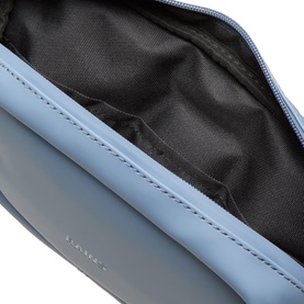 Rains Bum Bag in Blue Dusk, open top view showing black fabric interior lining and zip closure