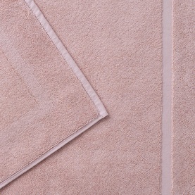 Christys Petal Pink bath towel with satin border trim, shown folded to display soft cotton terry texture.