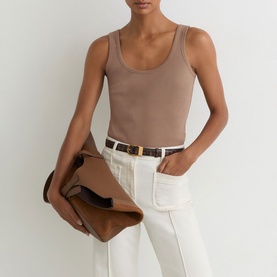 Model wearing Reiss taupe neutral tank top, styled with white jeans, brown leather belt, and carried tan leather clutch bag