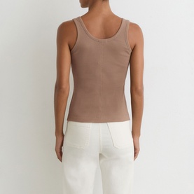 Model wearing Reiss taupe neutral ribbed vest top, back view, styled with white wide-leg trousers