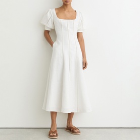 Model wearing Reiss white midi dress with square neckline, puff sleeves and A-line skirt, styled with tan flat sandals
