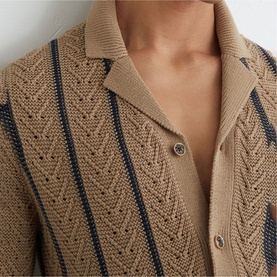 Model wearing Reiss light camel open-knit polo cardigan with navy stripe detail and button fastening, close-up of neckline and chest