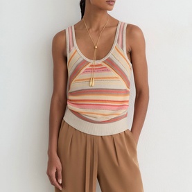 Model wearing Reiss beige multicolour stripe sleeveless knit top with scoop neck, styled with camel wide-leg trousers and gold necklace