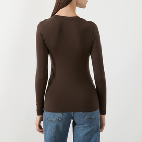 Model wearing Selected Femme knitwear in Delicioso brown, long-sleeve crew neck top, rear view, styled with blue jeans.