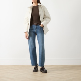 Model wearing Selected Femme Delicioso knitwear top, styled with cream jacket, blue straight-leg jeans and black chunky loafers