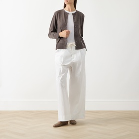 Model wearing Selected Femme Delicioso wool cardigan, styled with white T-shirt, wide-leg white trousers and taupe loafers.