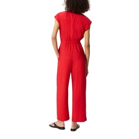 Model wearing Whistles red wide-leg jumpsuit with elasticated waist, cap sleeves and V-neckline, styled with black flat sandals.