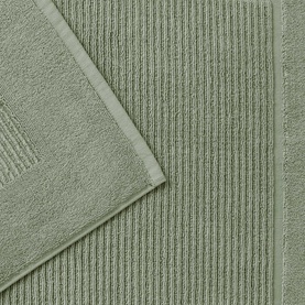 Christys Bath Towelling in Bay Leaf Green, ribbed border detail, shown folded to reveal soft looped texture.