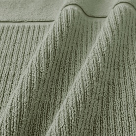 Christys Bath Towelling in Bay Leaf Green, close-up of ribbed cotton texture with scalloped border detail