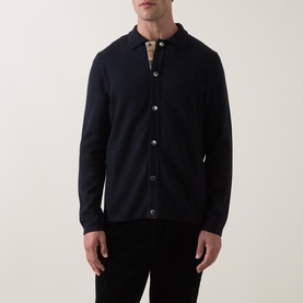 Model wearing Barbour Navy cardigan with button-front, polo collar and long sleeves, styled with dark trousers