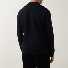 Model wearing Barbour Navy cardigan, rear view, showing ribbed cuffs and hem, styled with dark trousers.